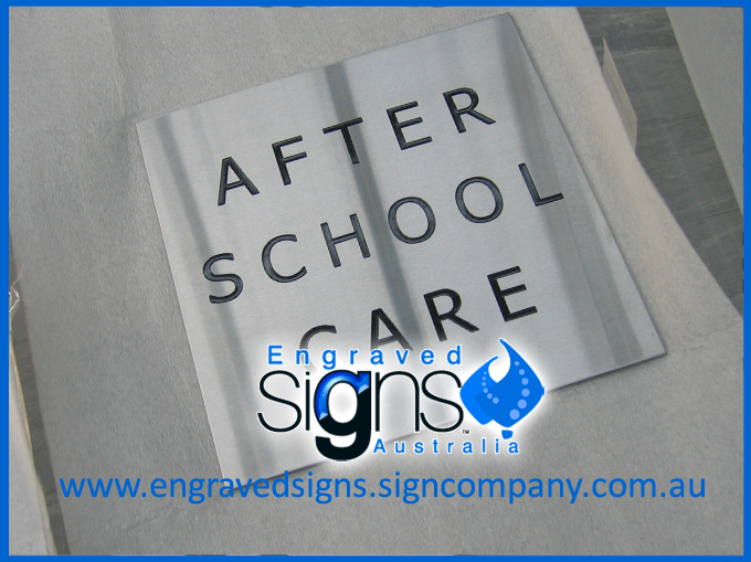 This After School Care sign is affixed to brick using epoxy glue. 